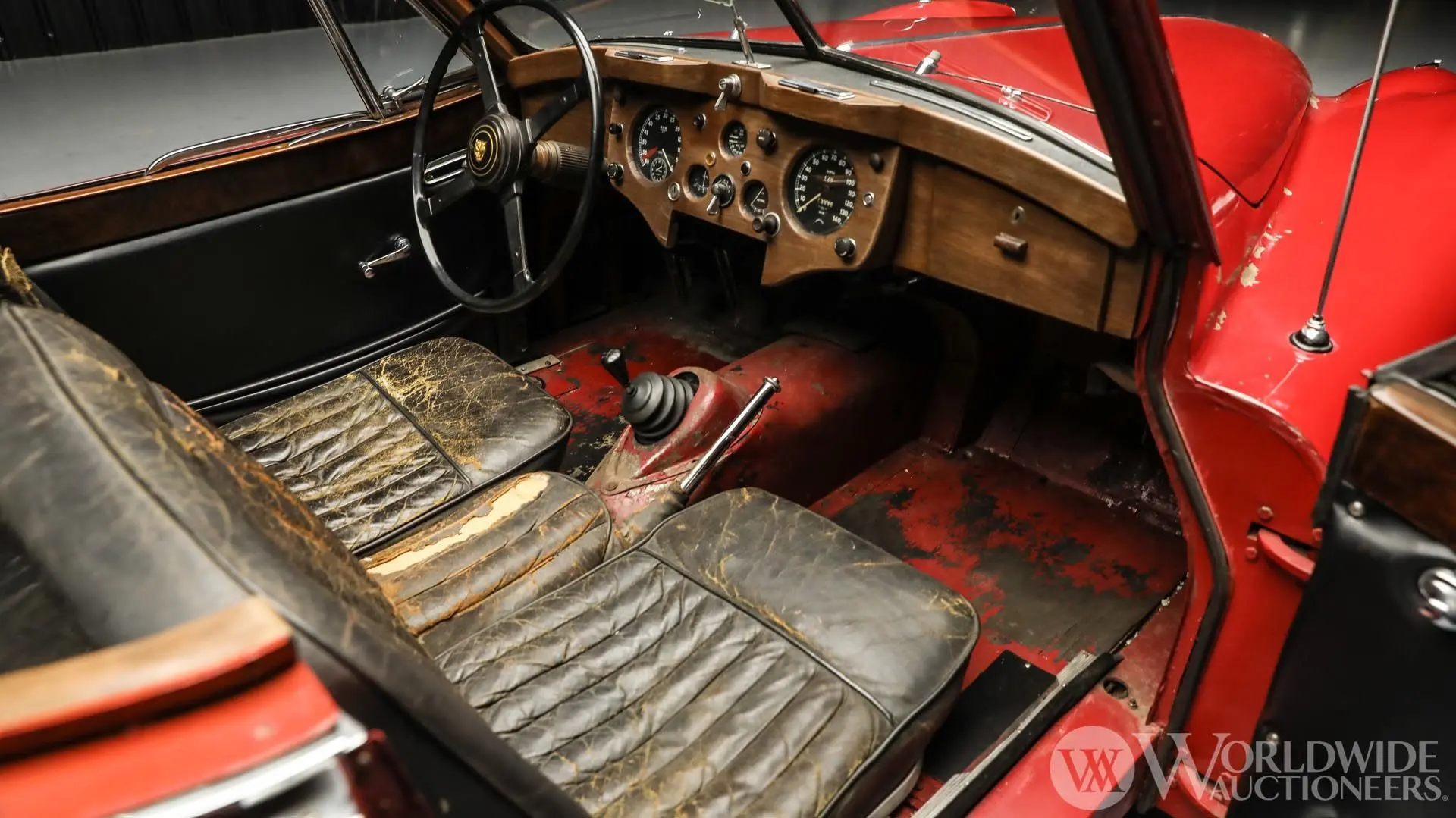 The Jaguar’s preserved interior retains the wear of a life that included road use, competition and decades in private hands. Photography courtesy Worldwide Auctioneers.